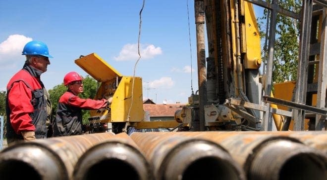 Oil drilling rig workers lifting drill pipe Photo by Robert Gerhardt 14274166