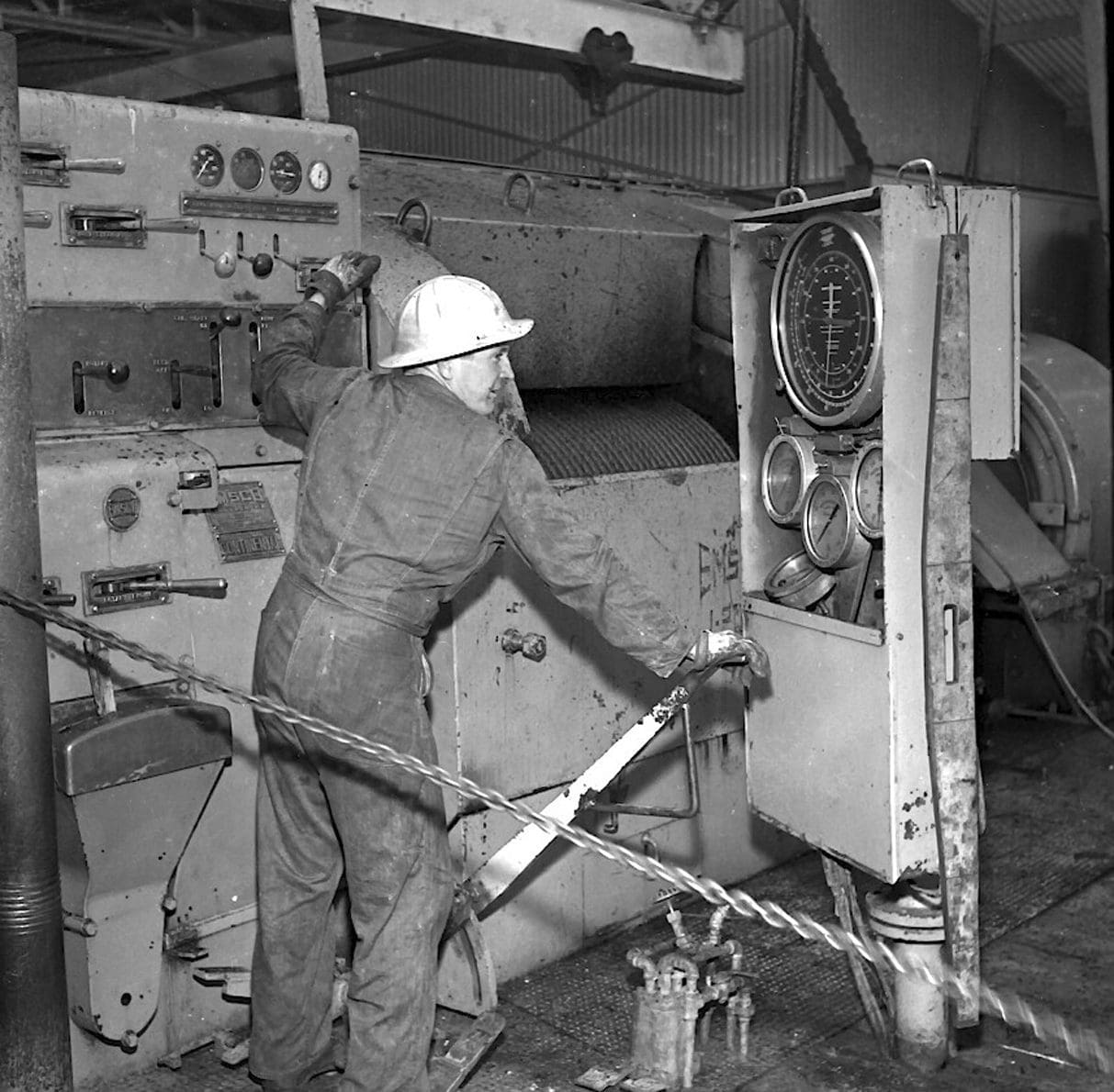 Oil Derrick Floor Roughneck Hand on the Controls