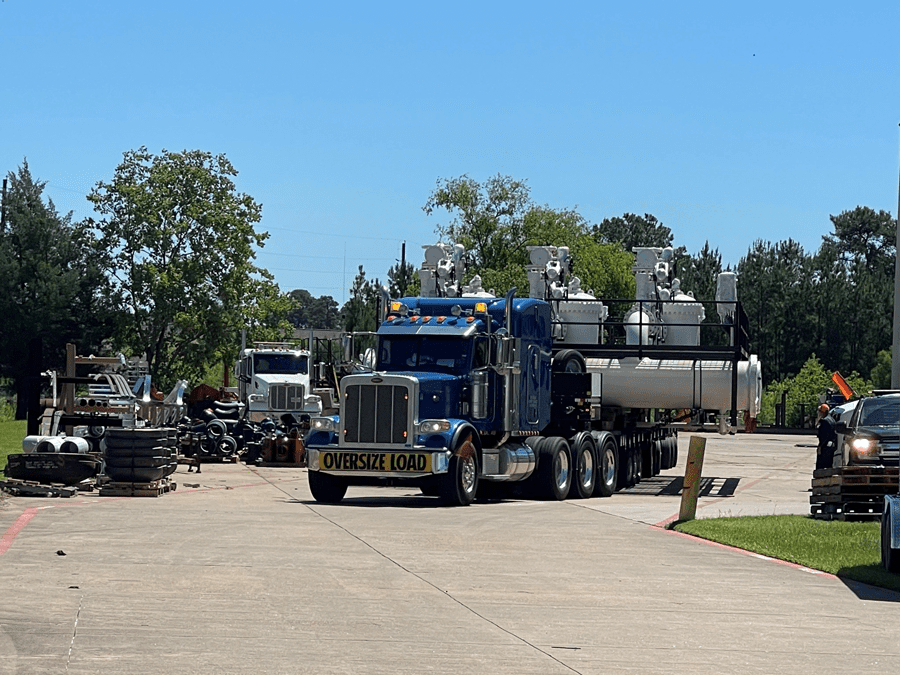 Truck hauling a 24’ wide meter skid on the Faymonville Highway Max trailer so this load could be steered out of the facility as the doors were only 26’ wide, not leaving much room for error. The trailer had to be raised multiple times enroute to clear bridges to prevent any damages. It was challenging to steer the trailer through tight areas to the unloading point at the delivery site.