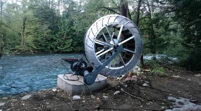 A Canadian man built a water wheel and ended up generating enough energy to power a home using only friction and gravity 13 water wheel next to river