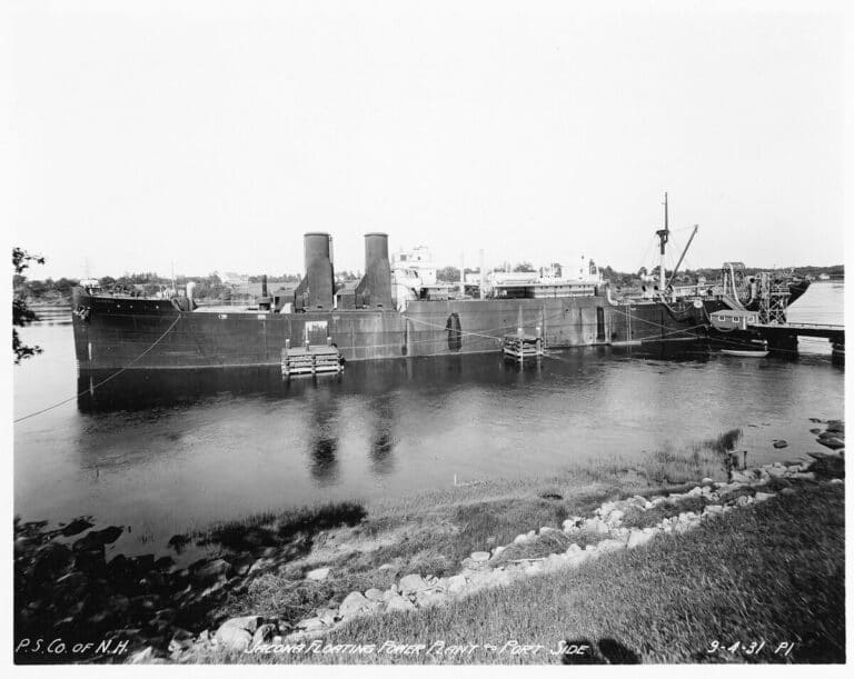 Rusting cargo ship converted into a floating power plant at dock